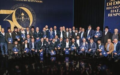 Some of Hatzolah's responders past and present with their awards at the 
30th anniversary gala dinner. Photo: Supplied.