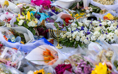 A chanukiah sits amid the floral tributes at Bondi. Photo: Michael Gara/Facebook