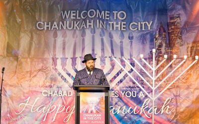 Rabbi Elimelech Levy welcomes attendees to Chanukah in the City at Sydney Town Hall. Photo: Sam Babus