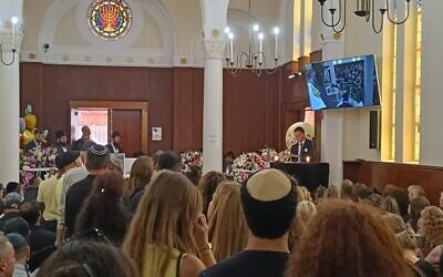 NSW Premier Chris Minns reading 'Ode to Matilda' at the funeral service on December 18. Photo: Shane Desiatnik