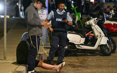 A policeman works at the scene of a shooting attack at a Chanukah event at Bondi Beach in Sydney. Photo: Saeed KHAN/AFP