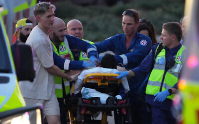 A person on a stretcher after a shooting at a Chanukah event at Bondi Beach. Photo: AP Photo/Mark Baker