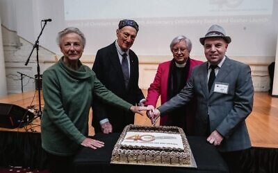 Celebrating 40 years with cake. From left: Sr Mary Lotton, Rabbi Dr John Levi, Archdeacon Dr Colleen O'Reilly, Alex Kats. Photo: supplied.