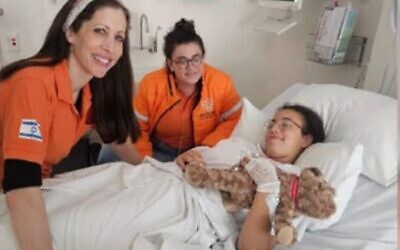 United Hatzalah in Sydney with a 14-year-old girl injured in the Bondi massacre. Photo: Facebook.