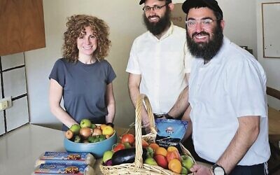Leah Boulton of Pathways Melbourne, with Yosi Wolf and Rabbi Shlomo Nathanson from 
C Care helping get Orly House ready for use. Photo: Pathways.