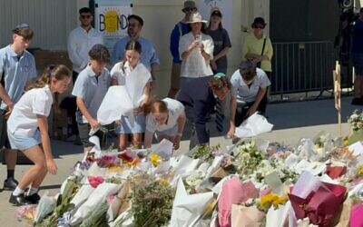 Moriah College students lay flowers at Bondi Pavilion on Friday, December 19.