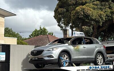 The burned our car being towed away. Photo: Supplied.