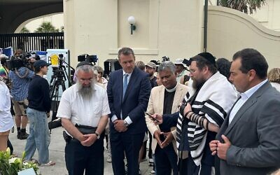 Steve Kamper (second from left) pays his respects at Bondi last week. Photo: Facebook