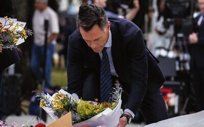Laying flowers at the Bondi memorial. Photo: Supplied