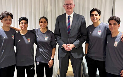 Five members of the Iranian women's football team with Home Affairs Minister Tony Burke. Photo: X