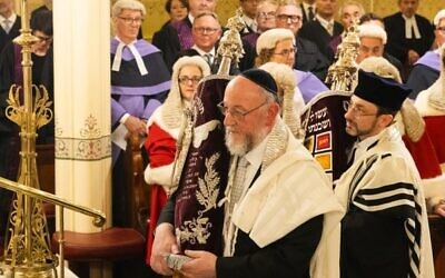 Rabbis Ephraim Mirvis and Benjamin Elton carry Torah scrolls as members of the judiciary look on. Photo: Giselle Haber