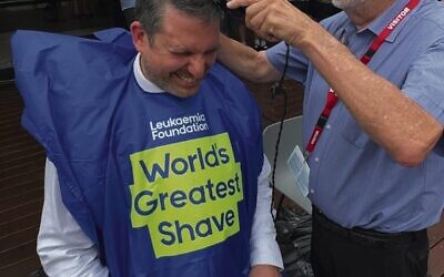 Fred Bergman shaving Principal Dan Sztrajt's hair.  
Photo: Mount Scopus Memorial College