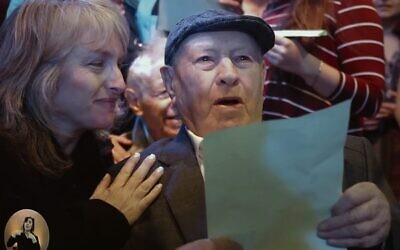A Holocaust survivor and his family member sing Chai as part of Koolulam.
 Photo: screenshot