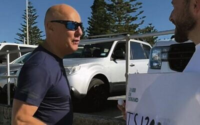 A man confronts Rabbi Yossi Friedman at Bondi Beach. 
Photo: Screenshot