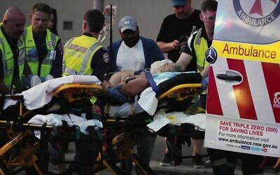 Emergency workers transport a person on a stretcher after the deadly terror shooting at Bondi Beach on December 14, 2025. Photo: AP/Mark Baker