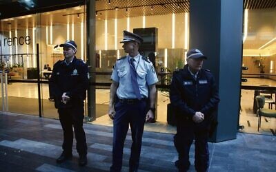 Acting Assistant Commissioner Andrew Garner (centre) stands guard with officers outside the Royal Commission building in the Sydney CBD. 
Photos: Gareth Narunsky