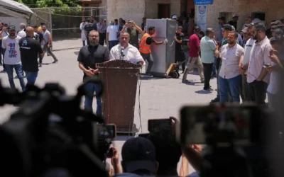 Ismail al-Thawabta, general director of the Hamas-run government media office, center right, speaks during a press conference at Al-Aqsa Hospital in Deir al-Balah, central Gaza Strip, July 6, 2026. (AP Photo/Jehad Alshrafi)
