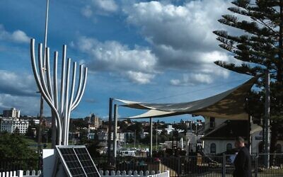 Itai Pessach pays his respects at the Bondi massacre memorial in Archer Park. Photo: Loretta Godfrey