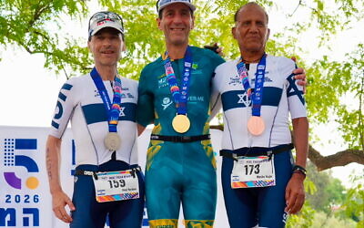 Australia's Barry Lipp (centre) wearing his Maccabiah Games men's 65+ duathlon gold medal on Friday on the podium, alongside runner-up Israel Boaz Yardeni (left) and bronze medallist Israeli Moshe Hajbi (right).