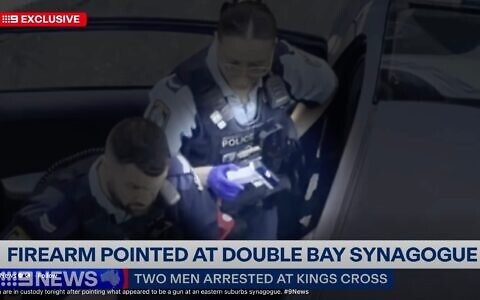 Police with the imitation firearm. Photo: Screenshot/Channel 9