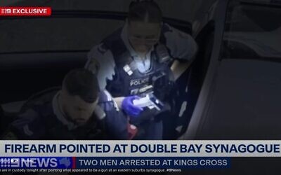 Police with the imitation firearm. Photo: Screenshot/Channel 9