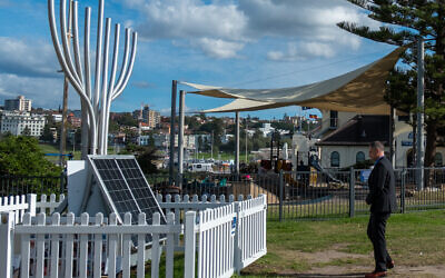 Itai Pessach pays his respects at the Bondi massacre memorial in Archer Park. Photo: Loretta Godfrey