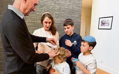 Zeide Ian Schwartz honoured with first cut of Itai Aron’s hair as family members watch.