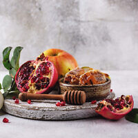Rosh Hashana Jewish New Year concept with honey, apple and pomegranate. Photo: Magnific.com