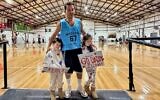 Elon Zizer with his two children last week in his first game for his Maccabi NSW Basketball Club open men's team since being shot in the Bondi Chanukah terror attack.
