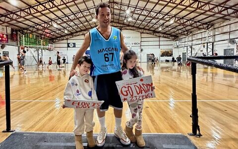 Elon Zizer with his two children last week in his first game for his Maccabi NSW Basketball Club open men's team since being shot in the Bondi Chanukah terror attack.