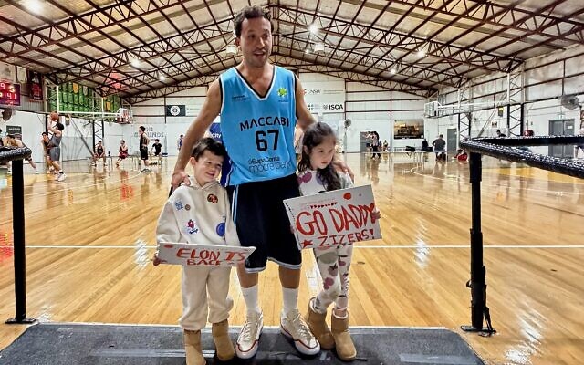 Elon Zizer with his two children last week in his first game for his Maccabi NSW Basketball Club open men's team since being shot in the Bondi Chanukah terror attack.