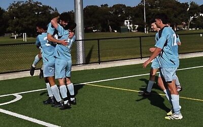 Maccabi's men's division 2 team celebrates after the winning goal was scored in their major semi-final win last Saturday.
