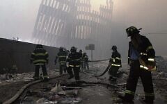 Firefighters work beneath the destroyed vertical struts that once faced the outer walls of the World Trade Centre towers. 
Photo: AP Photo/Mark Lennihan, File