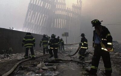 Firefighters work beneath the destroyed vertical struts that once faced the outer walls of the World Trade Centre towers. 
Photo: AP Photo/Mark Lennihan, File