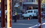 This frame grab taken from video footage provided by the Australian Broadcasting Corporation (ABC) on October 19, 2026 via AFPTV shows police officers at the scene after Australian independent lawmaker Helen Haines was struck by a car and suffered critical injuries outside her office in Wangaratta, about 200 kilometers northeast of Melbourne. (AFP/AUSTRALIAN BROADCASTING CORPORATION)