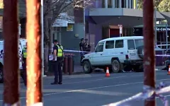This frame grab taken from video footage provided by the Australian Broadcasting Corporation (ABC) on October 19, 2026 via AFPTV shows police officers at the scene after Australian independent lawmaker Helen Haines was struck by a car and suffered critical injuries outside her office in Wangaratta, about 200 kilometers northeast of Melbourne. (AFP/AUSTRALIAN BROADCASTING CORPORATION)