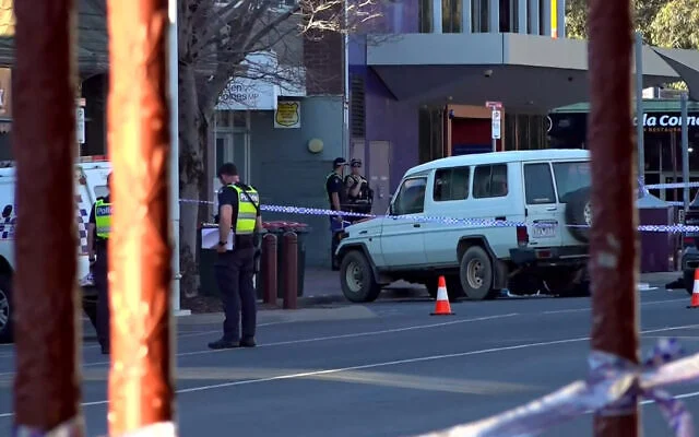 This frame grab taken from video footage provided by the Australian Broadcasting Corporation (ABC) on October 19, 2026 via AFPTV shows police officers at the scene after Australian independent lawmaker Helen Haines was struck by a car and suffered critical injuries outside her office in Wangaratta, about 200 kilometers northeast of Melbourne. (AFP/AUSTRALIAN BROADCASTING CORPORATION)