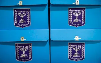 Workers prepare ballot boxes for the upcoming election at the Central Elections Committee warehouse in Shoham, ahead of their distribution to polling stations across the country, October 14, 2026. (Yonatan Sindel/Flash90)