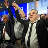 Joint List chair Yousef Jabareen and supporters gather at the party’s election headquarters in the northern Israeli city of Nazareth, following the closing of polling stations on election night, October 27, 2026. (Sharon Leibel/Flash90)