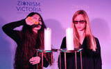 Hadar (left) and Noy light candles for the victims of October 7. Photo: Peter Haskin