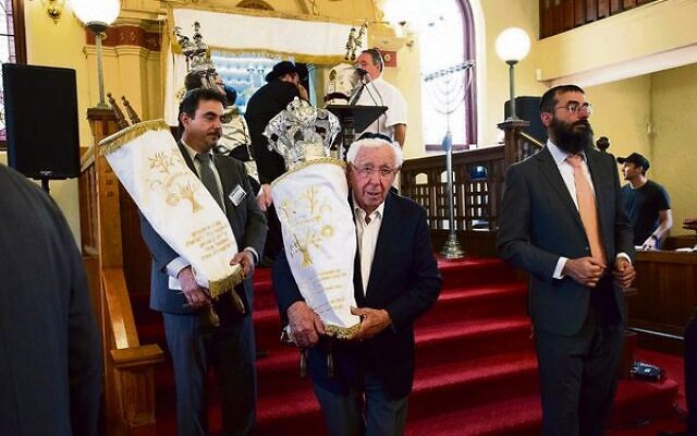 Frank Lowy carries a new Sefer Torah at a siyum marking 100 years of Newtown Synagogue in 2019.    Photo: Richard Weinstein