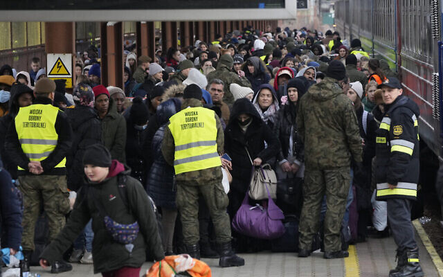 Refugees from Ukraine arrive to the railway station in Przemysl, Poland, Sunday, Feb. 27, 2022. Street fighting broke out in Ukraine's second-largest city Sunday and Russian troops put increasing pressure on strategic ports in the country's south following a wave of attacks on airfields and fuel facilities elsewhere that appeared to mark a new phase of Russia's invasion. (AP Photo/Czarek Sokolowski)