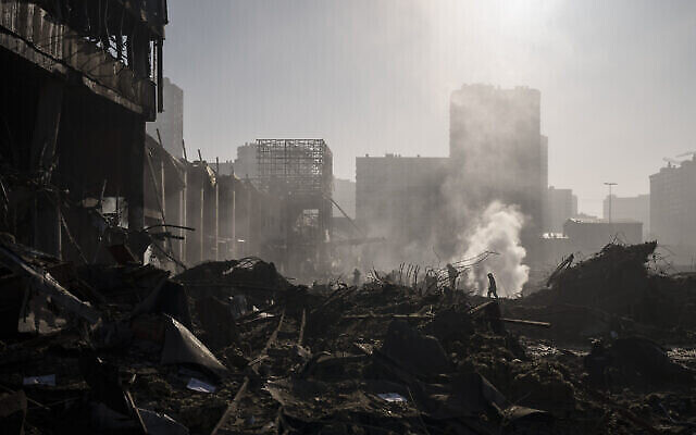 رجال الإطفاء يطفئون حريقا بالقرب من مركز تسوق بعد قصف في كييف، أوكرانيا، 21 مارس، 2022. (AP Photo / Felipe Dana)