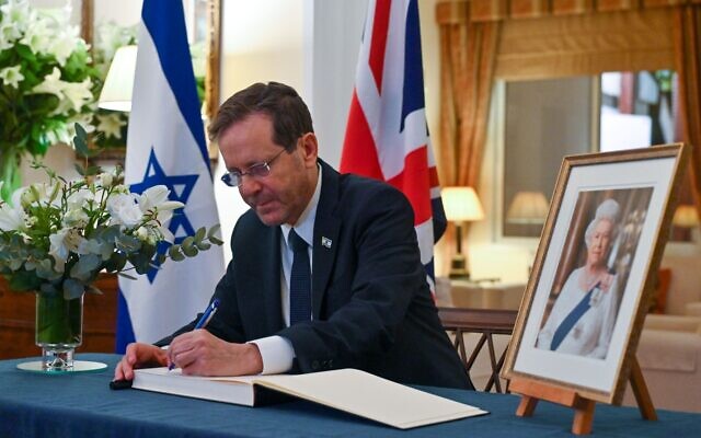 الرئيس إسحاق هرتسوغ يوقع كتاب تعزية للملكة إليزابيث الثانية في مقر إقامة السفير البريطاني في تل أبيب، 10 سبتمبر 2022 (Kobi Gideon / GPO)