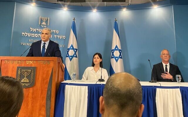 رئيس الوزراء يائير لبيد (يسار)، إلى جانب وزيرة الطاقة كارين الهرار (وسط) ووزير الدفاع بيني غانتس، يتحدثون إلى الصحافة في القدس حول صفقة الحدود البحرية الإسرائيلية اللبنانية، 12 أكتوبر 2022 (Lazar Berman / Times of Israel)