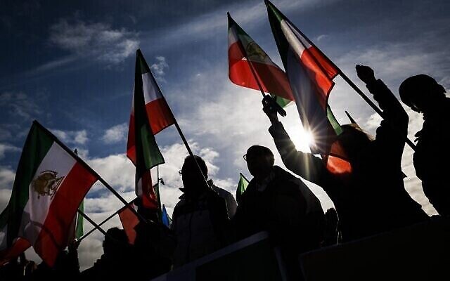 متظاهرون يلوحون بالأعلام الإيرانية السابقة للثورة الإسلامية أمام مقر الأمم المتحدة، أثناء مظاهرة وسط جلسة خاصة لمجلس حقوق الإنسان التابع للأمم المتحدة حول الوضع في إيران، في جنيف، 24 نوفمبر 2022 (VALENTIN FLAURAUD / AFP)
