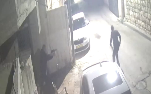 Naim Badir attempts to open fire with a makeshift submachine gun during an attack against police officers in Kafr Qasim, early December 23, 2022. (Israel Police)