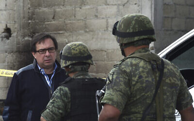 المدير السابق لوكالة التحقيقات الجنائية المكسيكية، توماس زيرون (يسار)، إلى المنزل الواقع في نهاية النفق الذي كان من الممكن أن يهرب من خلاله تاجر المخدرات المكسيكي خواكين "إل تشابو" غوزمان من سجن ألتيبلانو، في ألمولويا دي خواريز، المكسيك، 12 يوليو، 2015. (AFP / YURI CORTEZ)