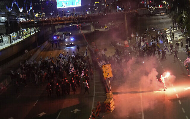 متظاهرون يغلقون طريقا سريعا خلال احتجاج على خطط حكومة رئيس الوزراء بنيامين نتنياهو لإصلاح النظام القضائي في تل أبيب، 25 مارس، 2023. (AP Photo / Ariel Schalit)