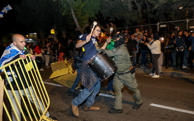 الشرطة تشتبك مع متظاهر خارج منزل رئيس الوزراء بنيامين نتنياهو في القدس، 26 مارس 2023 (Noam Revkin Fenton / Flash90)
